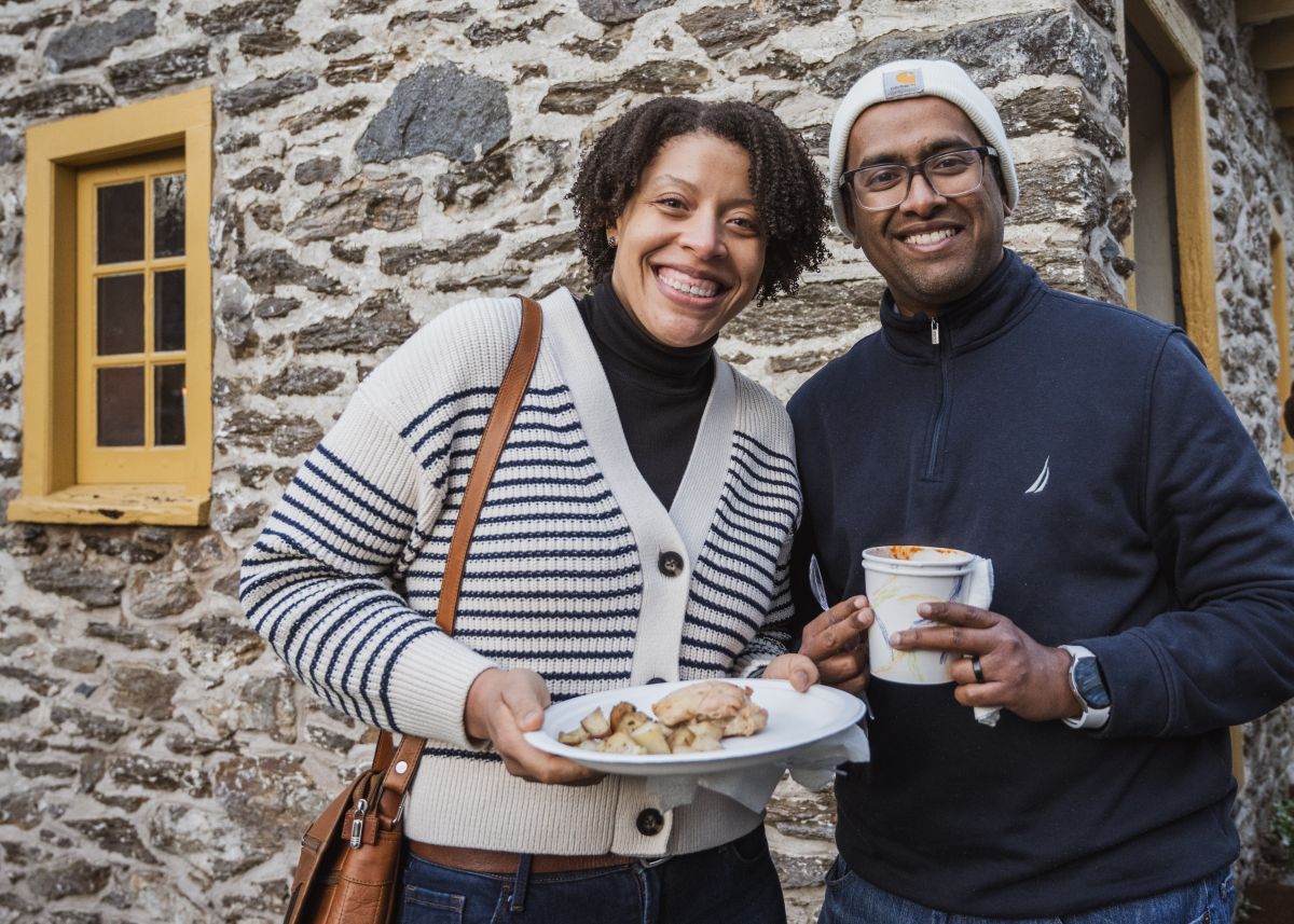 Two people smiling with food at Historic RittenhouseTown